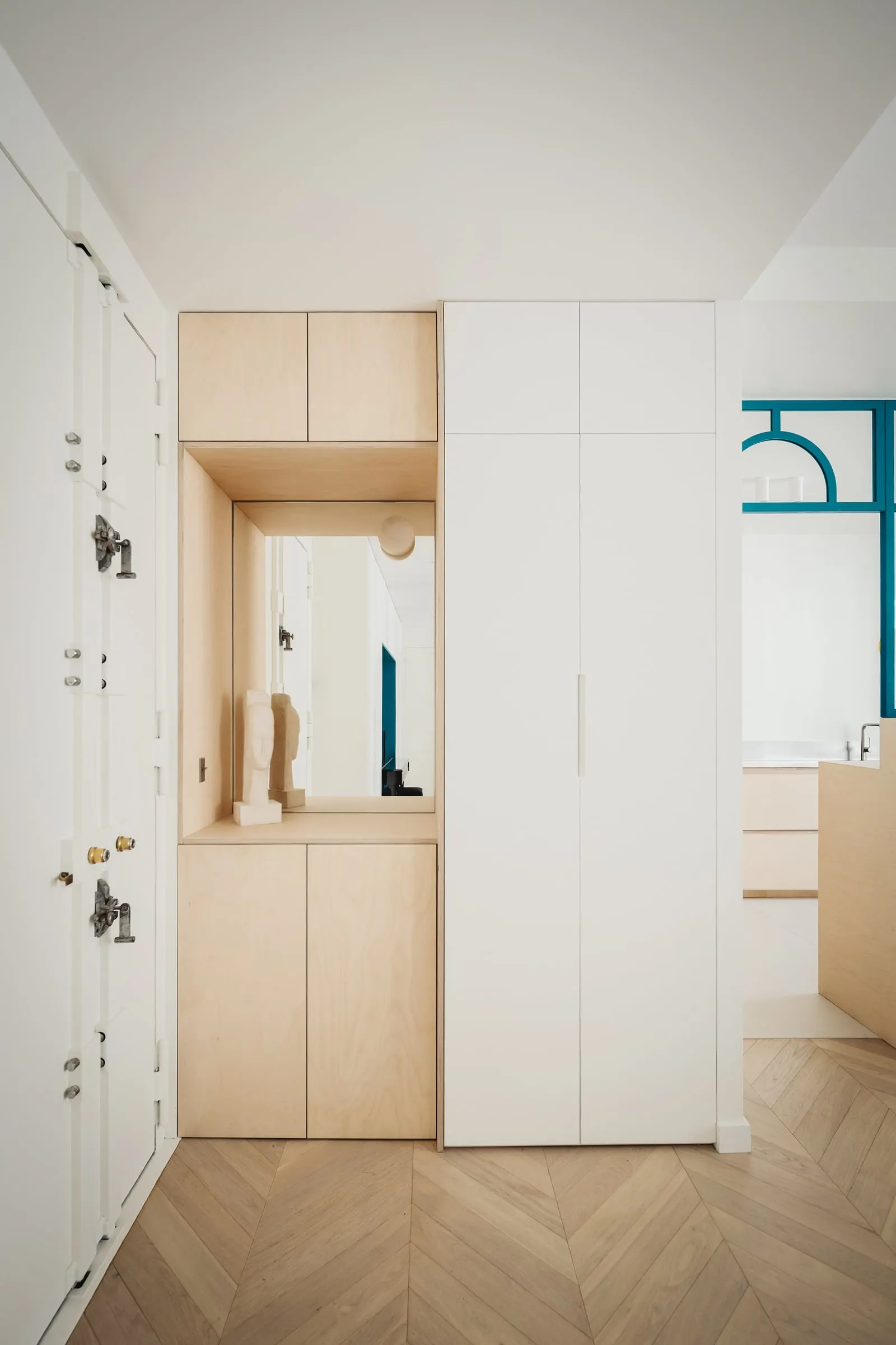 Entrée avec rangements en contreplaqué de bouleau et parquet à bâtons rompus