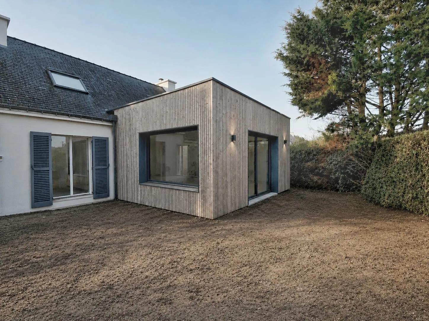 Extension en bardage bois accolée à une maison bretonne, côté jardin